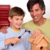 Homeschool dad and son building a birdhouse
