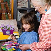 child and grandmother painting for homeschool handicraft