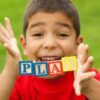homeschool boy spells play with letter blocks